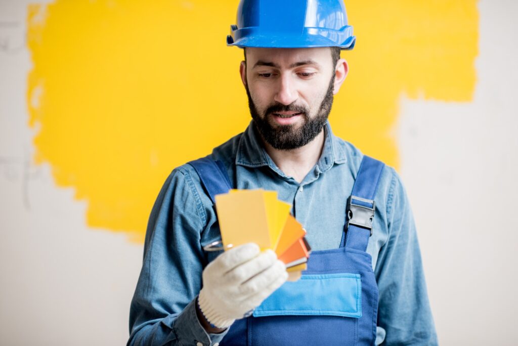 Painter with color swatches indoors